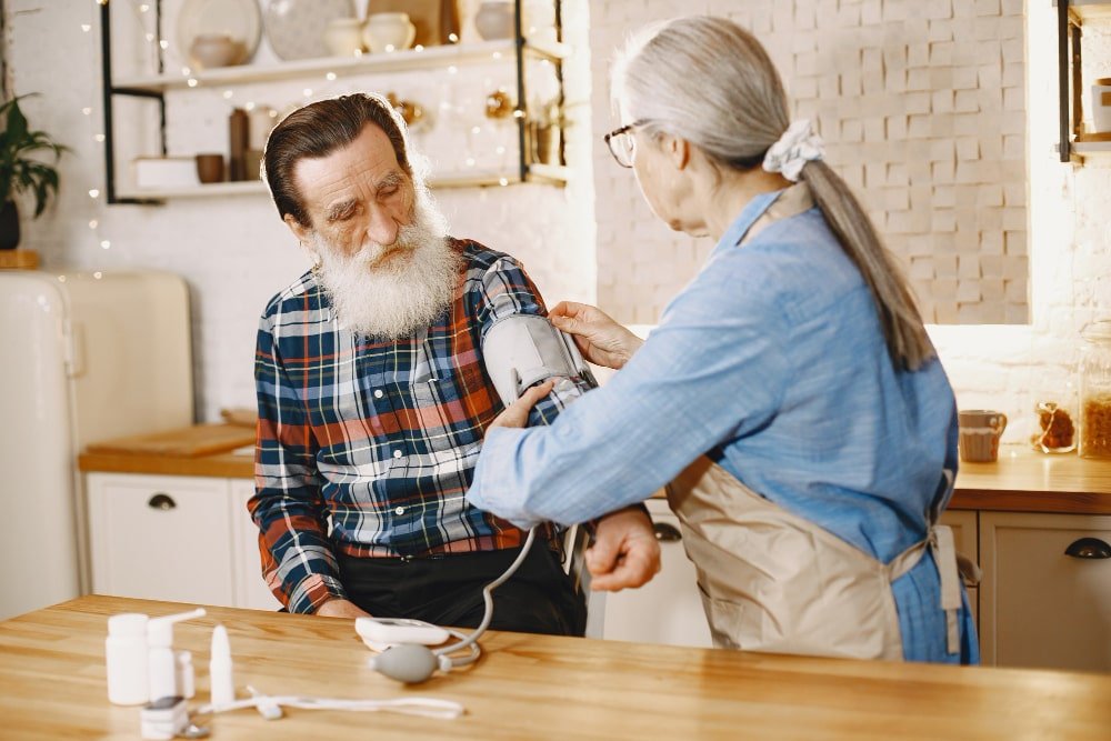 emporary Adult Care Jobs with Highbridge Care Solutions A caregiver takes the blood pressure of an elderly man, highlighting the importance of skilled professionals in adult care.